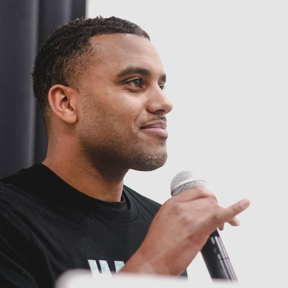 Headshot of Olatunde Sobomehin speaking into microphone